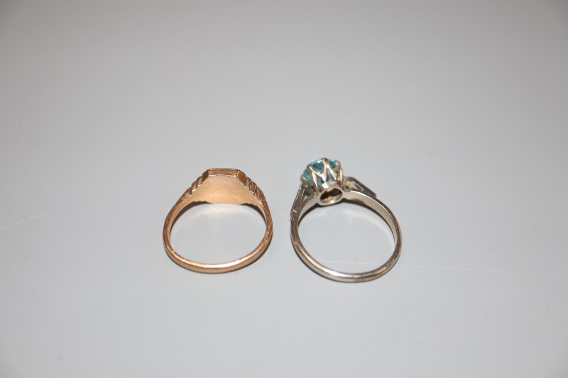 A 9ct gold signet ring(worn), 2.8 grams and a white metal and blue zircon(worn) dress ring, size N, gross 2.5 grams.